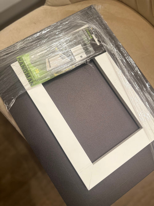 Back of AcryliScope acrylic birth chart panel with wall‑mounting tools packaged and attached for installation